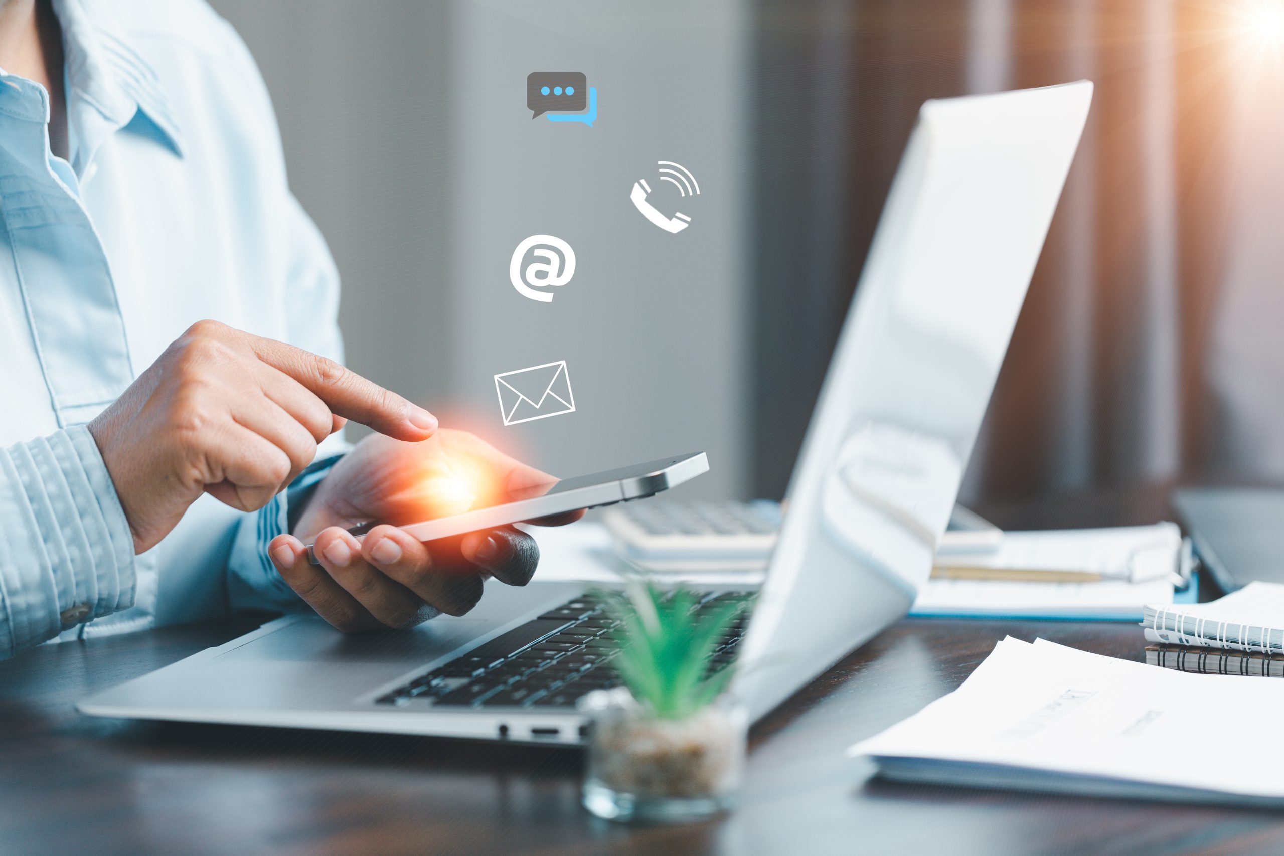 businesswoman using phone and touching on virtual screen contact icons such as email, address, live chat, internet wifi. contact us or customer support hotline people connect. connect with cyberspace.
